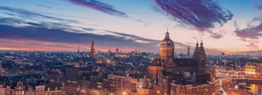 A cityscape of Amsterdam in the Netherlands featuring iconic elements of Amsterdam's architectural landmarks.