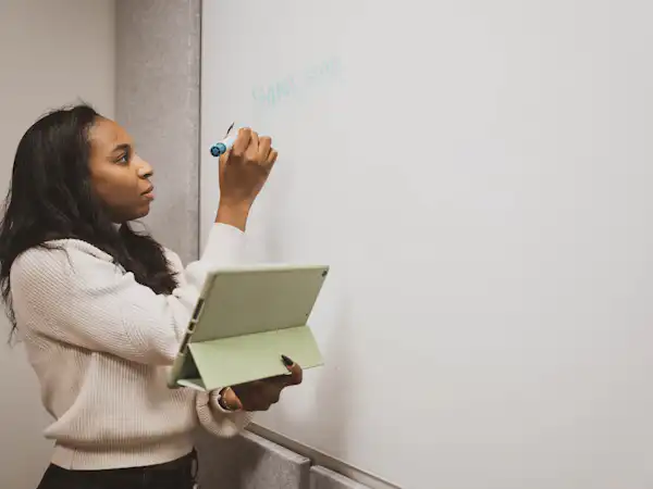 Student writing on whiteboard