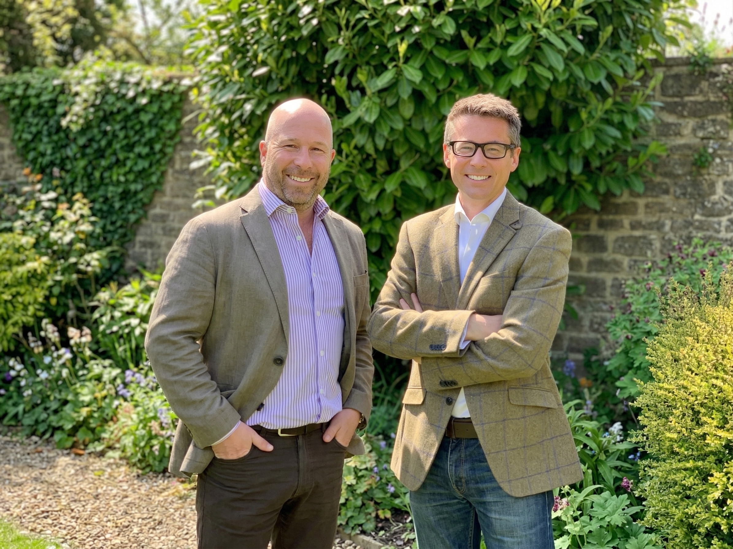 Chris Morling and Simon Andrews, founders of Studee, stand smiling in a garden setting.