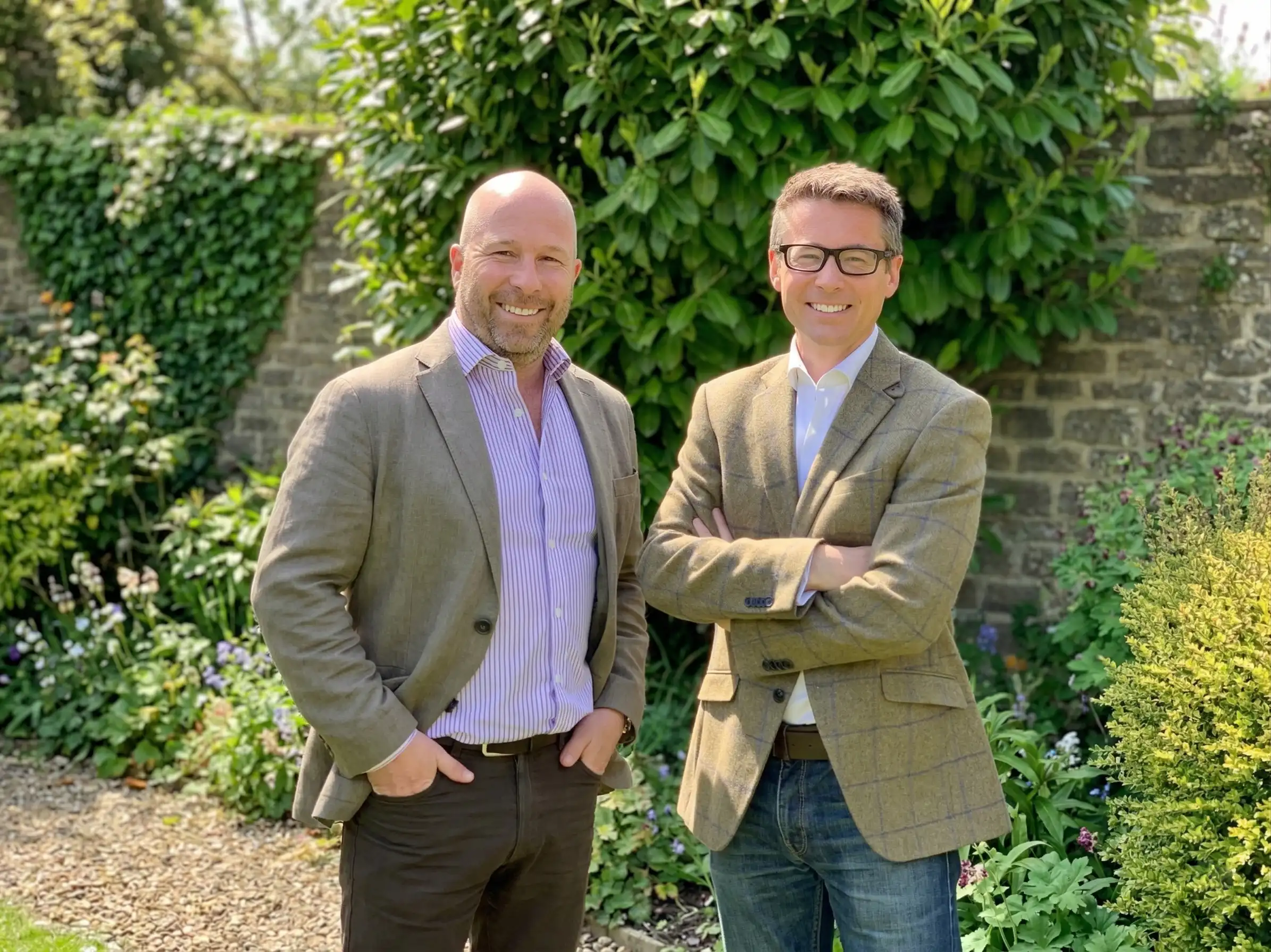 Chris Morling and Simon Andrews, founders of Studee, stand smiling in a garden setting.
