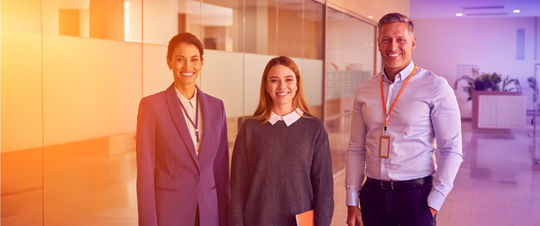 A female school counselor, female student and male university admissions officer stand confidently in a bright university space, representing Studee's mission to simplify international admissions for schools, students, and universities.