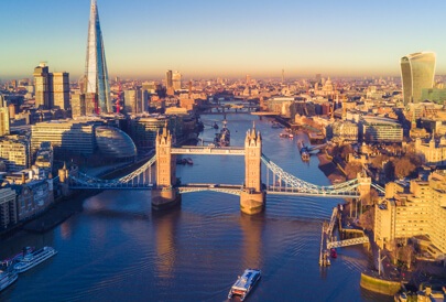 Aerial view of London Bridge with high rise buildings and a river.