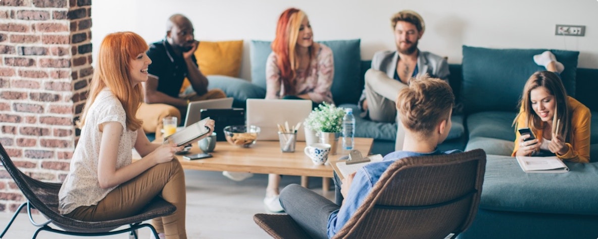 Group of students planning a presentation in a living room