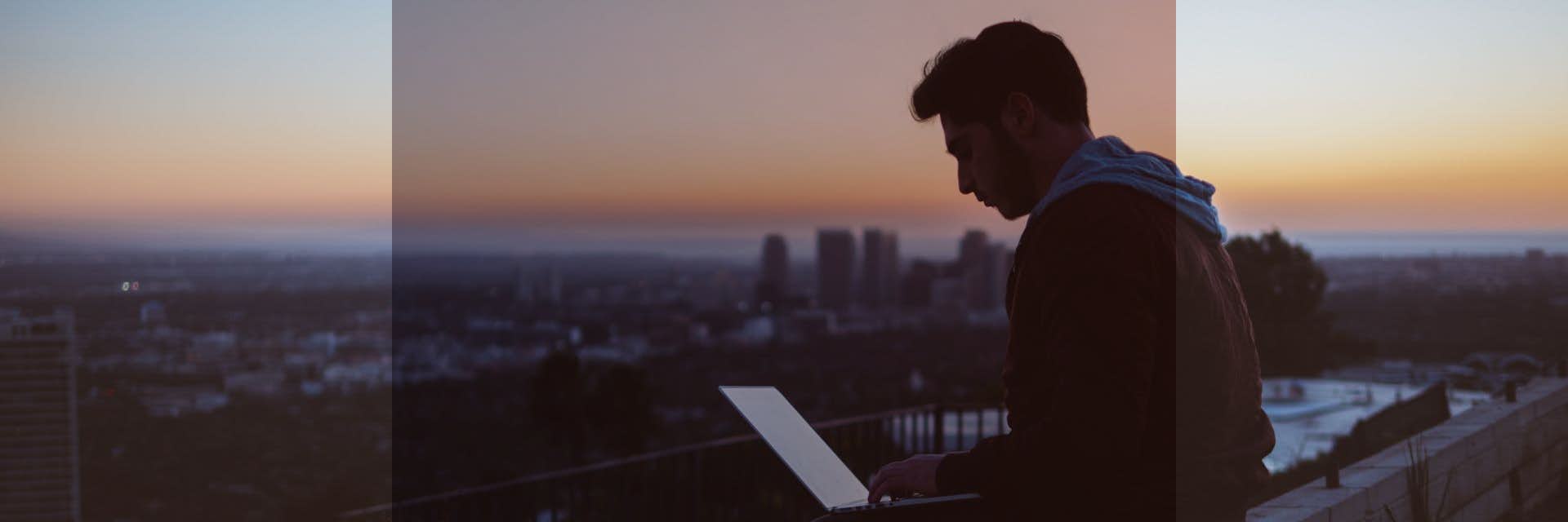 Man sitting looking at laptop