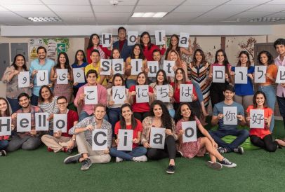 The Studee team all holding signs saying Hello in different languages 