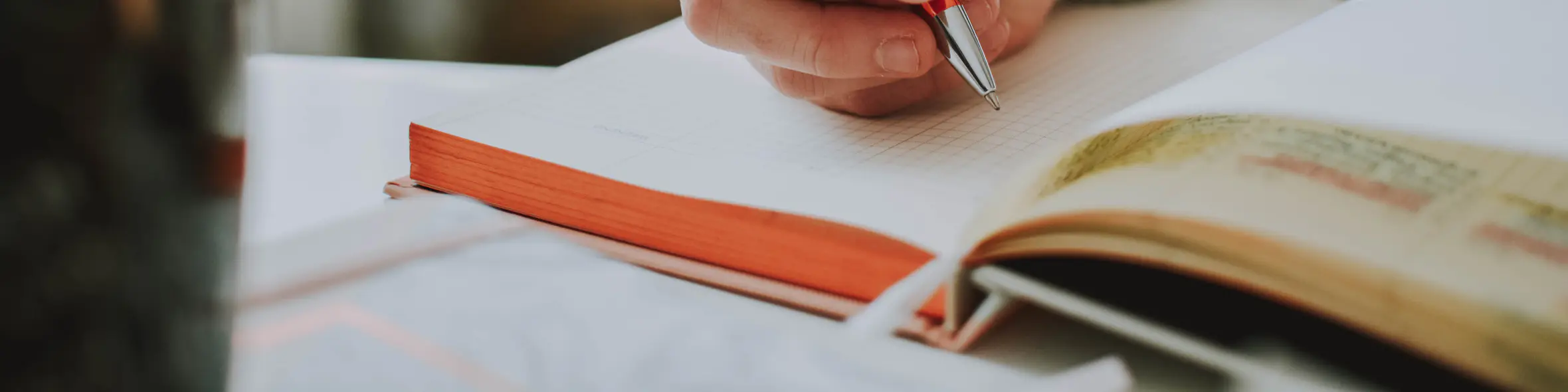 Person writing in notebook
